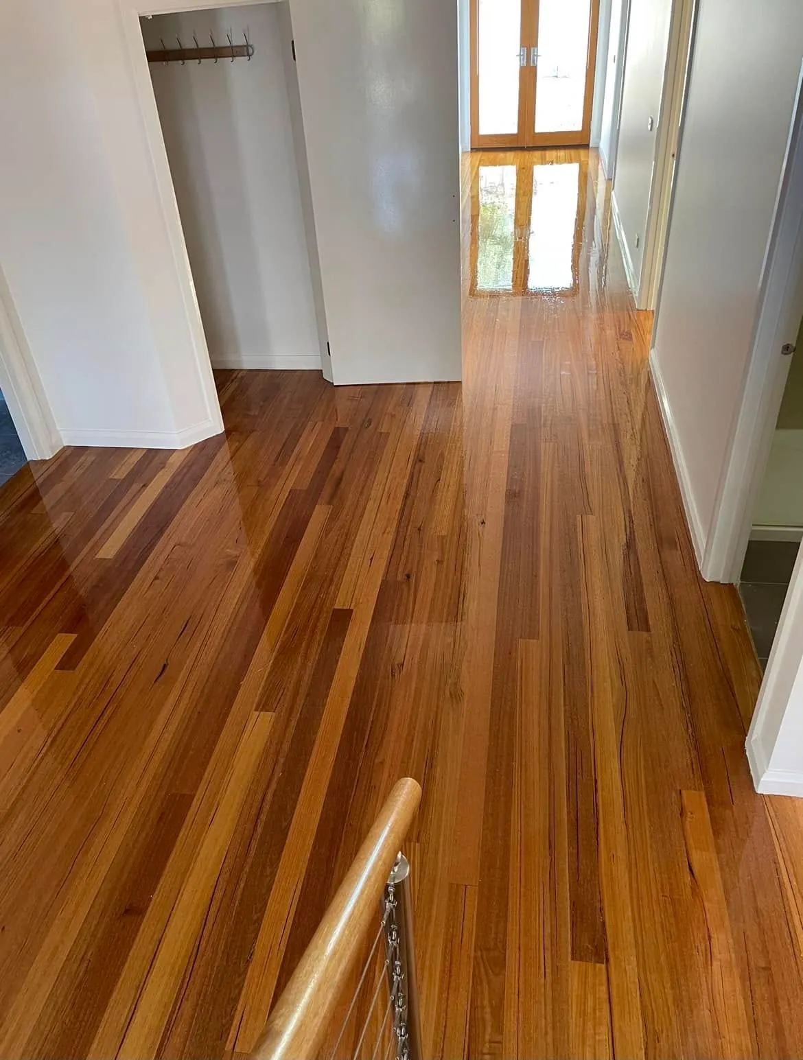 High-gloss timber flooring running down a hallway