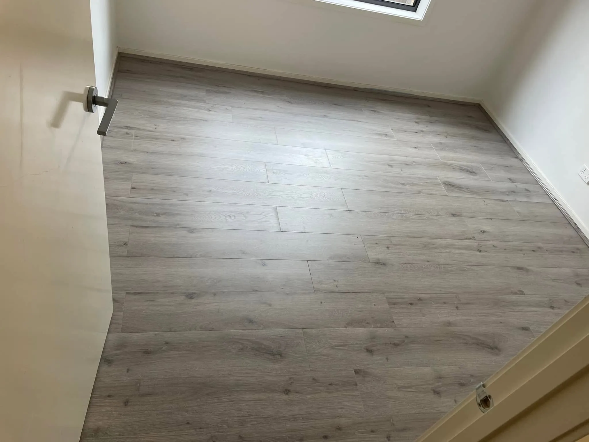 Light grey flooring in an empty room